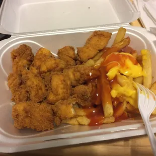 fried chicken and fries in a styrofoam container