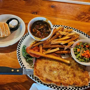 Schweine Jäger Schnitzel, side of dark mushroom gravy, fries, overcooked peas &amp; carrots, roll &amp; butter