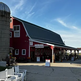 a red barn and white benches