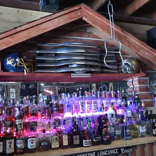 a shelf full of liquor bottles
