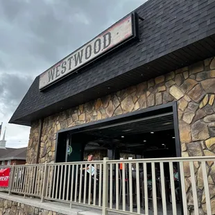 Front of bar featuring roll up garage door for outdoor/indoor space