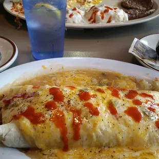 First bite. I love w this burrito. Food is deliciously fresh. Highly recommend the breakfast burrito smothered in green chili.