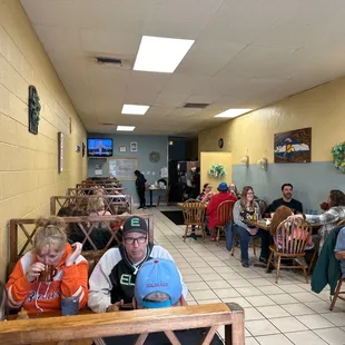 people sitting at tables and eating