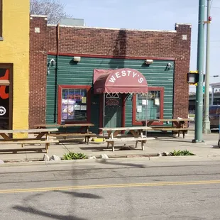 a street corner with tables and benches