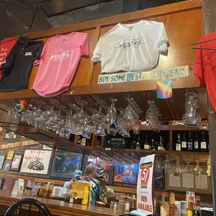 t - shirts and wine glasses on a shelf