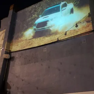 Large projection screen television outside.