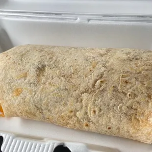  a burrito in a styrofoam container