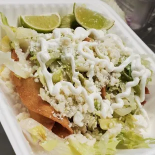 Tacos Dorados served with sour cream, lettuce and cheese