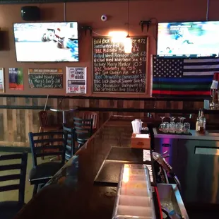 a bar with two televisions on the wall