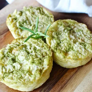 three mini quiches on a cutting board