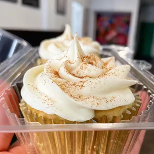 a hand holding a cupcake