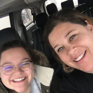 two women in the back of a car