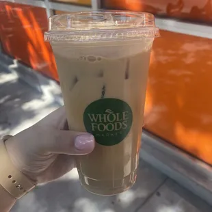 a hand holding a cup of coffee