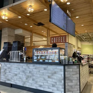 a brick counter with a sign above it