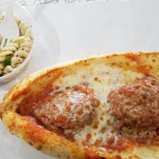a slice of pizza and a bowl of macaroni salad