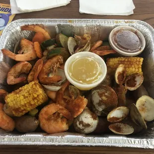 Build your own with shrimp, clams, sausage, veggies, and corn