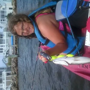 Allie fishing with her dad behind the ship.