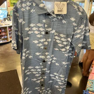 a blue shirt with white fish on it