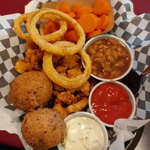 Fried clams, steamed carrots, hush puppies, onion rings, and beans
