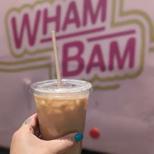 a hand holding a cup of coffee