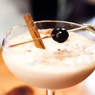 a drink with a cinnamon stick in it