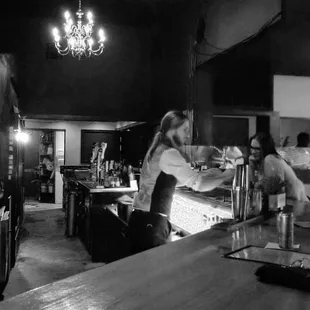 a black and white photo of a bar