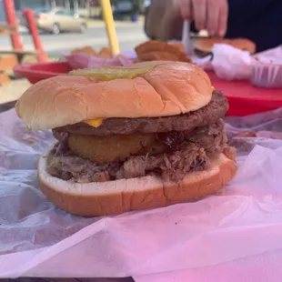 Bost burger with Pulled pork and an onion ring on top