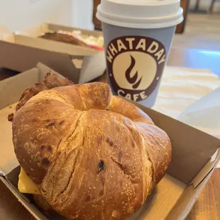 a croissant sandwich and coffee