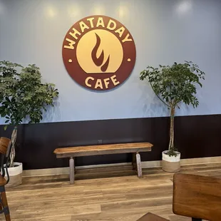 a wooden bench in front of a sign