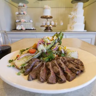 Steak &amp; Romaine  grass fed steak, grilled romaine, parmigiano-reggiano, tomatoes, roasted corn, red onions &amp; cilantro-lemon vinaigrette