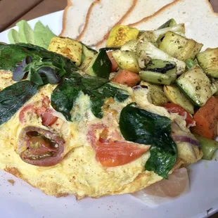 French Omelette with prosciutto, organic baby heirloom tomato, red onion, spinach &amp; ricotta cheese with side of roasted seasonal vegetables.