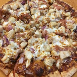 BBQ Chicken Pizza: BBQ Sauce, Mozzarella Cheese, Red Onions, Bacon, Diced Chicken