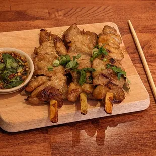 Pork belly skewers, chopstick for scale