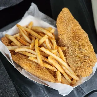 a basket of fried fish and fries