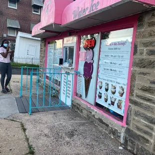 a woman standing outside of a shop