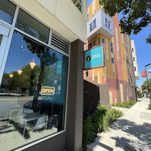 a view of a building from the sidewalk