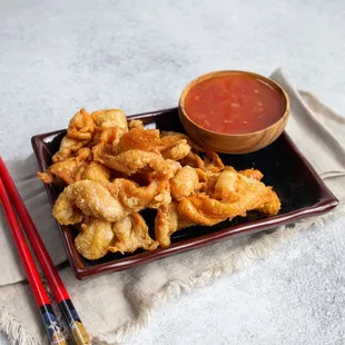 a plate of fried shrimp and dipping sauce