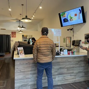 two people standing at a counter