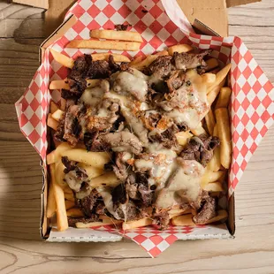 a box of fries with meat and cheese