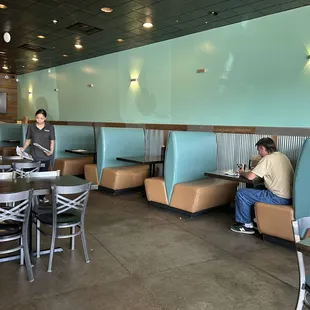 a man sitting at a table in a restaurant