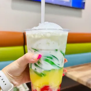 a person holding a drink with a straw