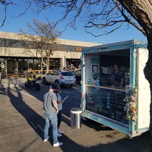 a man standing in front of a food truck