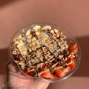 a person holding a bowl of food