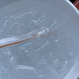 a cup of water with a spoon sticking out of it