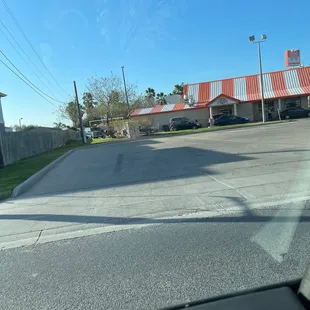 a view of a parking lot from inside a car
