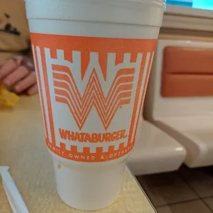 a plastic cup with a straw