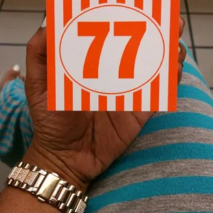 a person holding a box of 7 sevens