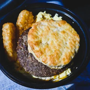 a hamburger with a biscuit on top