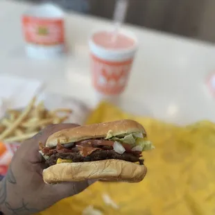 a person holding a sandwich