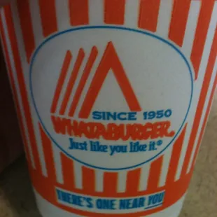 a hand holding a cup of coffee